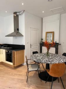 - une cuisine et une salle à manger avec une table et des chaises dans l'établissement Le petit toulousain chic, à Toulouse