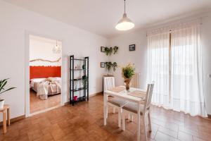 a dining room with a table and a bedroom at Acquaterra in Polignano a Mare