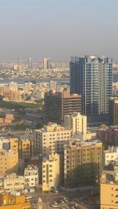 vista su una città con molti edifici alti di fantastic city & Seaview Master bedroom in 3bedroom apartment ad Ajman