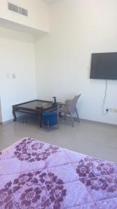 a living room with a table and a purple rug at fantastic city & Seaview Master bedroom in 3bedroom apartment in Ajman 