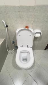 a bathroom with a white toilet in a stall at fantastic city & Seaview Master bedroom in 3bedroom apartment in Ajman 