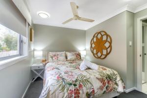a bedroom with a bed and a ceiling fan at Experience this Stylish Brisbane Apartment in Brisbane