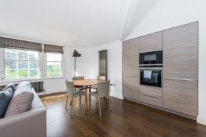 a living room with a table and a couch at Cool urban apartment with stunning Castle views in Edinburgh