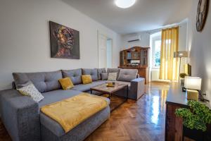 a living room with a couch and a table at Apartment Sorelle Fiume in Rijeka +21 photos