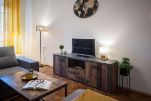 a living room with a flat screen tv on a wooden entertainment center at Apartment Sorelle Fiume in Rijeka