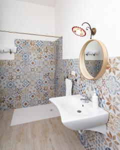 a bathroom with a sink and a mirror at Monte Pirastru in Nughedu San Nicolò