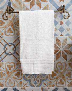 a white towel hanging on a towel rack at Monte Pirastru in Nughedu San Nicolò