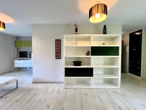a white book shelf in a living room at Castelao AP in Santiago de Compostela