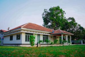 a small white house with a red roof at The Chapters in Jaffna
