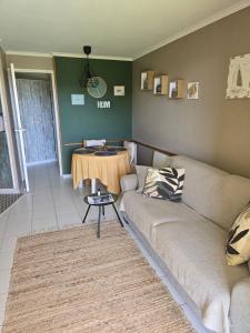 a living room with a couch and a table at Magic mer in Saint-Raphaël