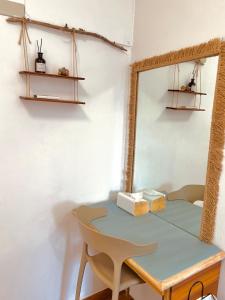 a table and chair in a room with a mirror at 水青潛水旅宿 Water Blue in Green Island