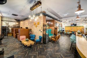 a restaurant with tables and chairs and a brick wall at Hotel Memories OldTown in Budapest