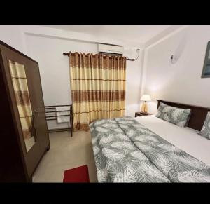 a bedroom with a bed and a window at Araliya Uyana Apartments - Two Bed Room House in Ratmalana