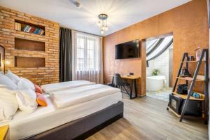 a bedroom with two beds and a brick wall at Hotel Memories OldTown in Budapest