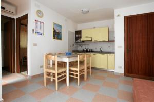 a kitchen with a table and chairs in a room at Villa Chiara in Rosolina Mare