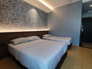 Voodi või voodid majutusasutuse Lumut Hotel toas
