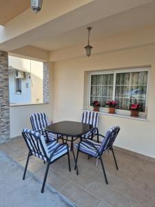 a patio with a black table and chairs at Pansion Speranza Međugorje in Međugorje