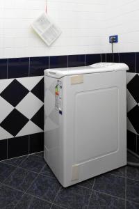 a washing machine in a bathroom with black and white tiles at Villa Adriana in Rosolina Mare