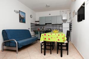 a kitchen with a table and a blue chair at Villa Adriana in Rosolina Mare