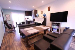 a living room with a table and chairs and a tv at Yatsugatake Guest House Matsuda House - Vacation STAY 11086 in Hokuto
