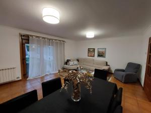 a living room with a table and a couch at O Alecrin de Bouzas Ribeira Sacra in Pereiro de Aguiar