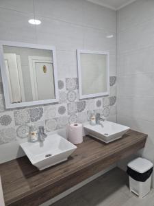a bathroom with two sinks and a mirror at Pansion Speranza Međugorje in Međugorje