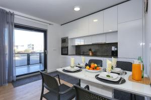 a kitchen and dining room with a table and chairs at Apartment Wali in Nin