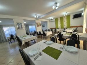 a dining room with white tables and chairs at Pansion Speranza Međugorje in Međugorje