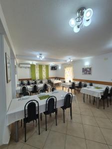 a conference room with tables and chairs in a room at Pansion Speranza Međugorje in Međugorje