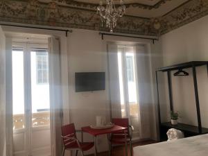 a bedroom with a bed and a table and chairs at Grand Via House in Madrid