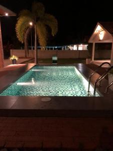 珍南海灘的住宿－Rooma Kichi Private Pool，夜间游泳池,灯光照亮