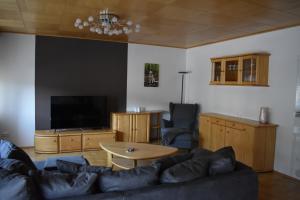 a living room with a couch and a table at Ferienwohnung Rhönmarkt in Ostheim +10 photos