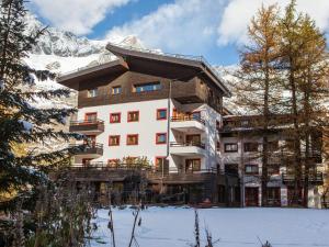 a building in the mountains with snow on the ground at Contemporary Apartment in Breuil Cervinia near Ski Area in Breuil-Cervinia