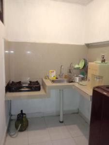 a small kitchen with a sink and a stove at Dee homes singaraja in Singaraja