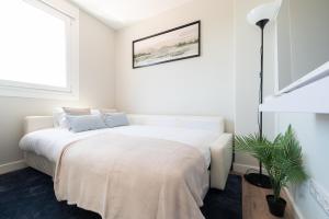 ein weißes Schlafzimmer mit einem großen weißen Bett. in der Unterkunft El Atico de la Ria in Vigo
