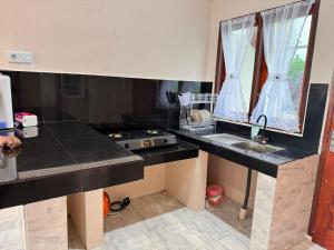 a kitchen with a sink and a counter top at NADELS HOMESTAY SYARIAH in Gadut