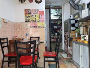 a restaurant with chairs and a table in a room at OYO 90972 Jj Homestay in Miri