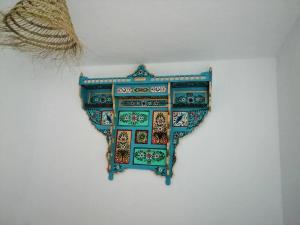 a blue and green plate hanging on a wall at Maison de ville sousse in Sousse