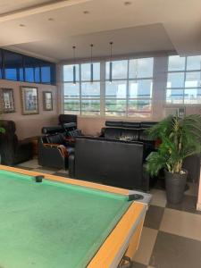a pool table in a living room with furniture at THE GROOVE GUEST HOUSE in Lagos