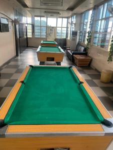 a row of pool tables in a room at THE GROOVE GUEST HOUSE in Lagos