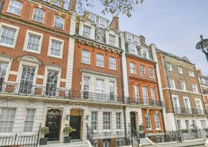a row of buildings on a city street at Darley House by Viridian Apartments in London