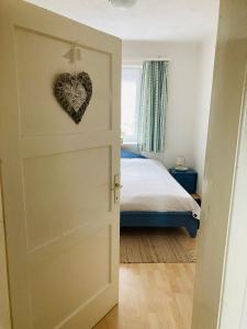 a bedroom with a door with a heart on it at Das Ferienhaus-zurück zum Ursprung in Güssing