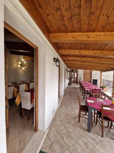 a dining room with tables and chairs on a patio at Agriturismo Orrido di Pino in Agerola