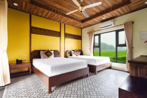 Ліжко або ліжка в номері Dong Ne Tam Coc Hotel & Resort