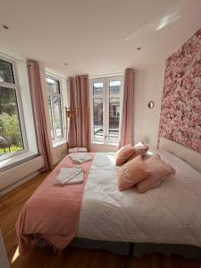 a bedroom with a large bed with two pillows at Victorias House Suite in Lille
