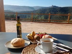 a table with a cup of coffee and a plate of food at El Bujeo Montefrio in Montefrío
