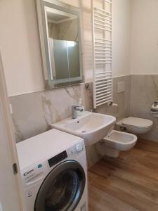 a bathroom with a washing machine and a sink at Sweet Home Francesco & Chiara in Chioggia