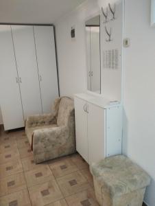 a dressing room with a chair and a mirror at Family guesthouse in forest Ana & Stjepan Nikolić in Međugorje