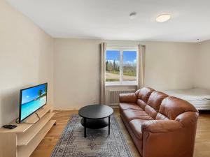 a living room with a couch and a television at Equipped Apartments, Perfect For Workers 