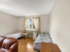 a living room with a couch and a bed and a window at Equipped Apartments, Perfect For Workers 